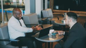 Two guests in conversation, illustrating how to become a guest on Candid Over Coffee