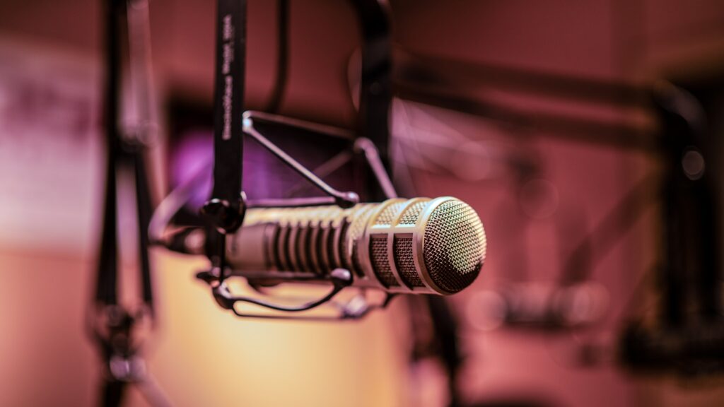 Microphone in a recording studio representing the topics Candid Over Coffee explores